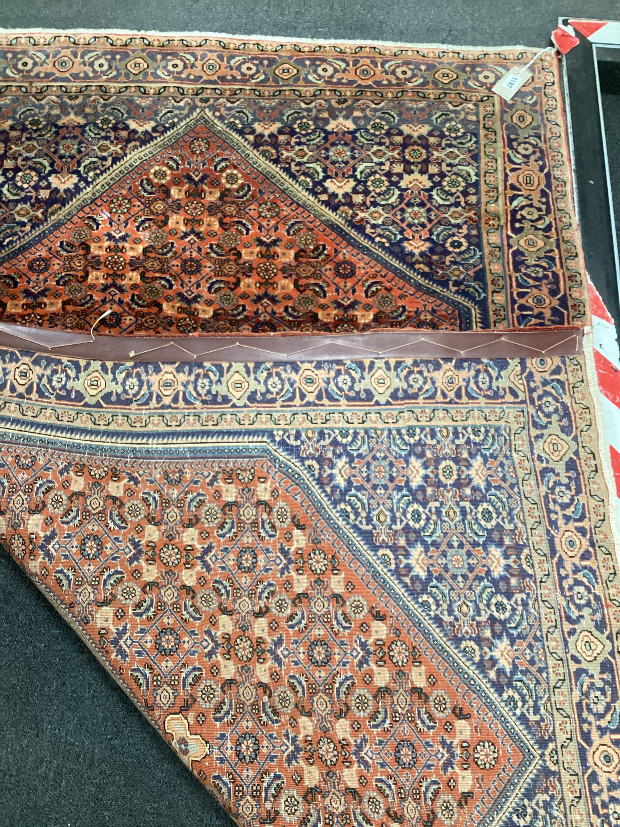 A North West Persian part silk red ground rug, 180 x 116cm